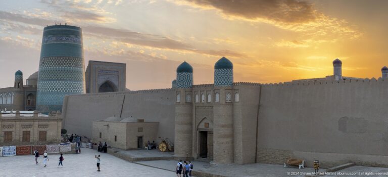 Sunset over domes and fortified walls.