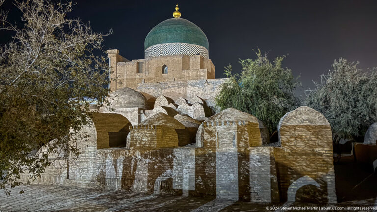 Green-domed mausoleum behind cemetery markers.