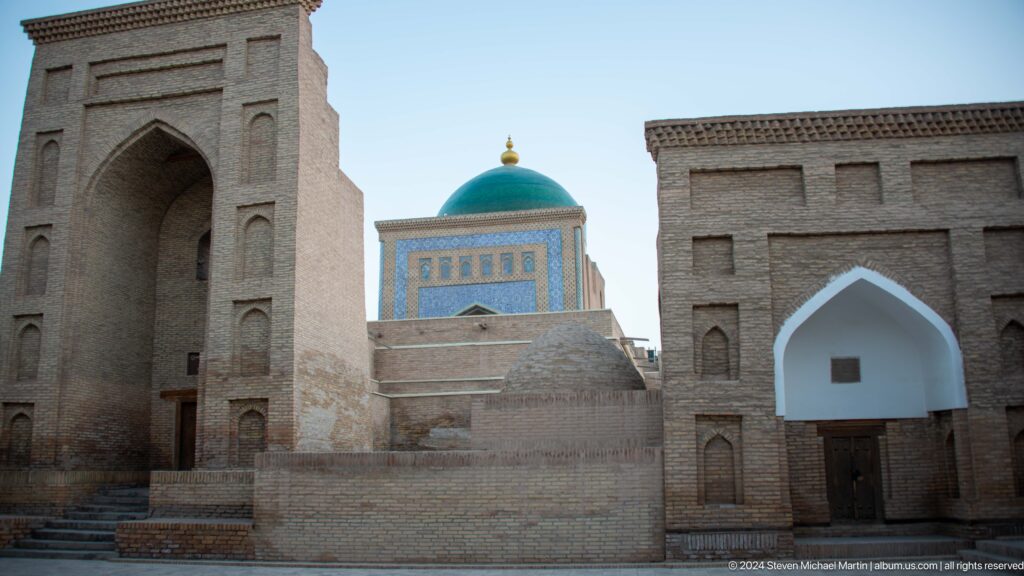 Green dome framed by brick monuments.