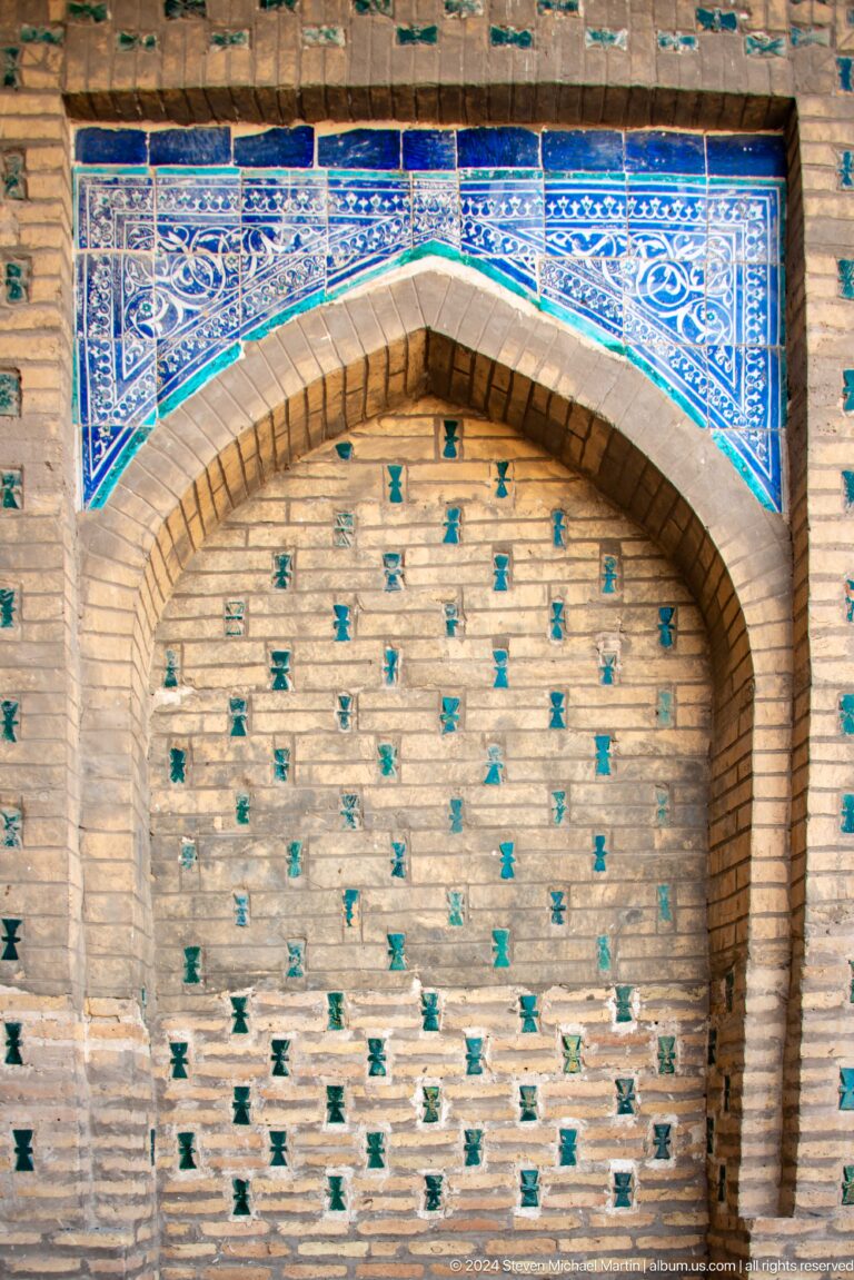 Brick arch inset with turquoise glazed pegs.
