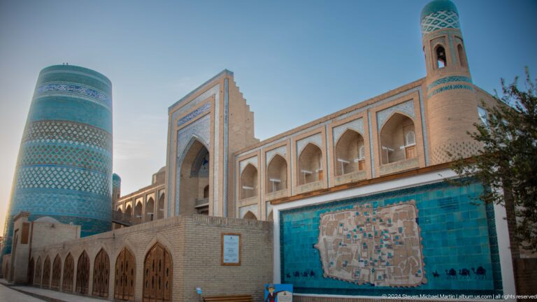 Kalta minor and long madrasa facade with visitor map.