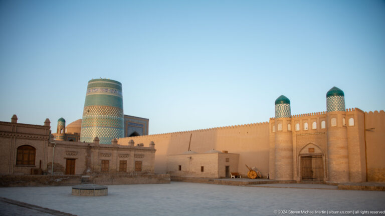 Broad courtyard with kalta minor and city walls.