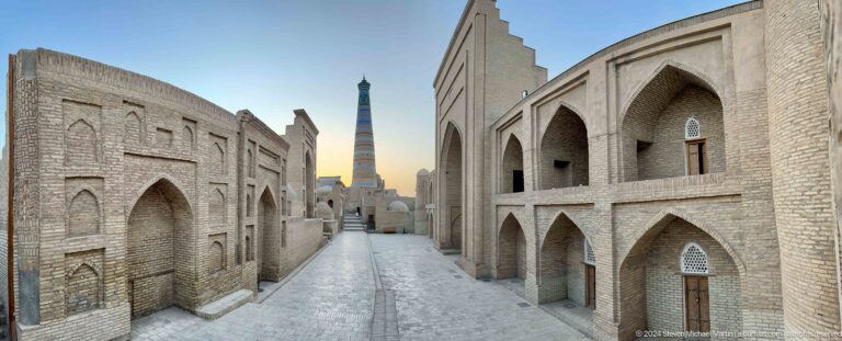 Empty lane with minaret and monumental facades.