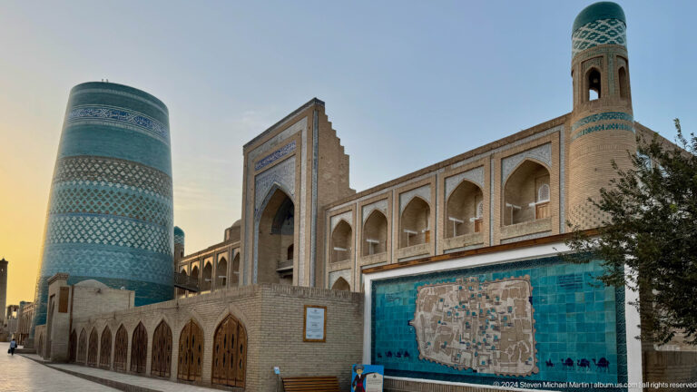 Kalta minor and madrasa facade with wall map.