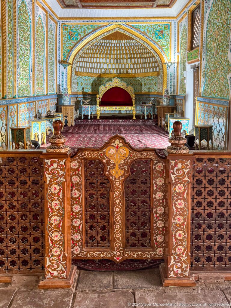 Ornate audience hall with carved balustrade and throne niche.