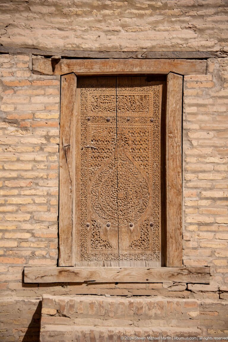 Intricately carved wooden door panel.