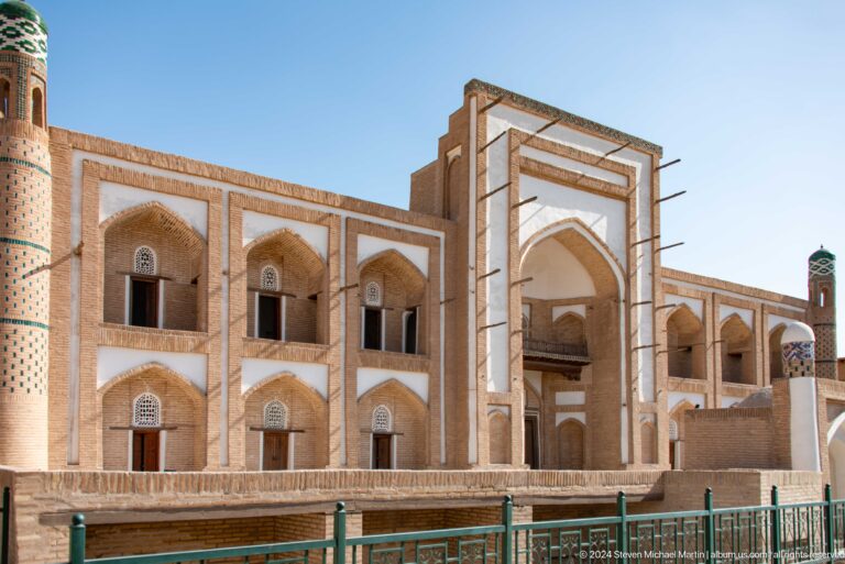 Two-story madrasa facade with tall central portal.