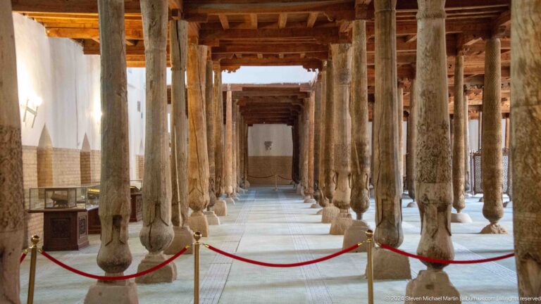 Roped aisle among ancient wooden columns.