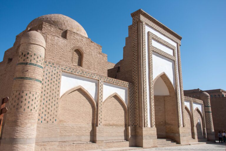 Monumental brick portal with pointed arches.