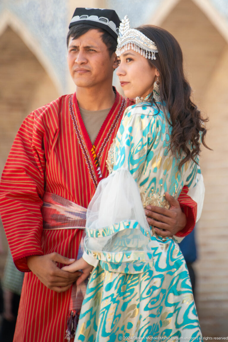 Close view of visitor wearing red and patterned scarves.