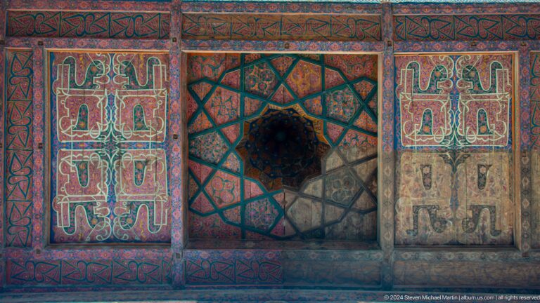Painted wooden ceiling panel with central star medallion.