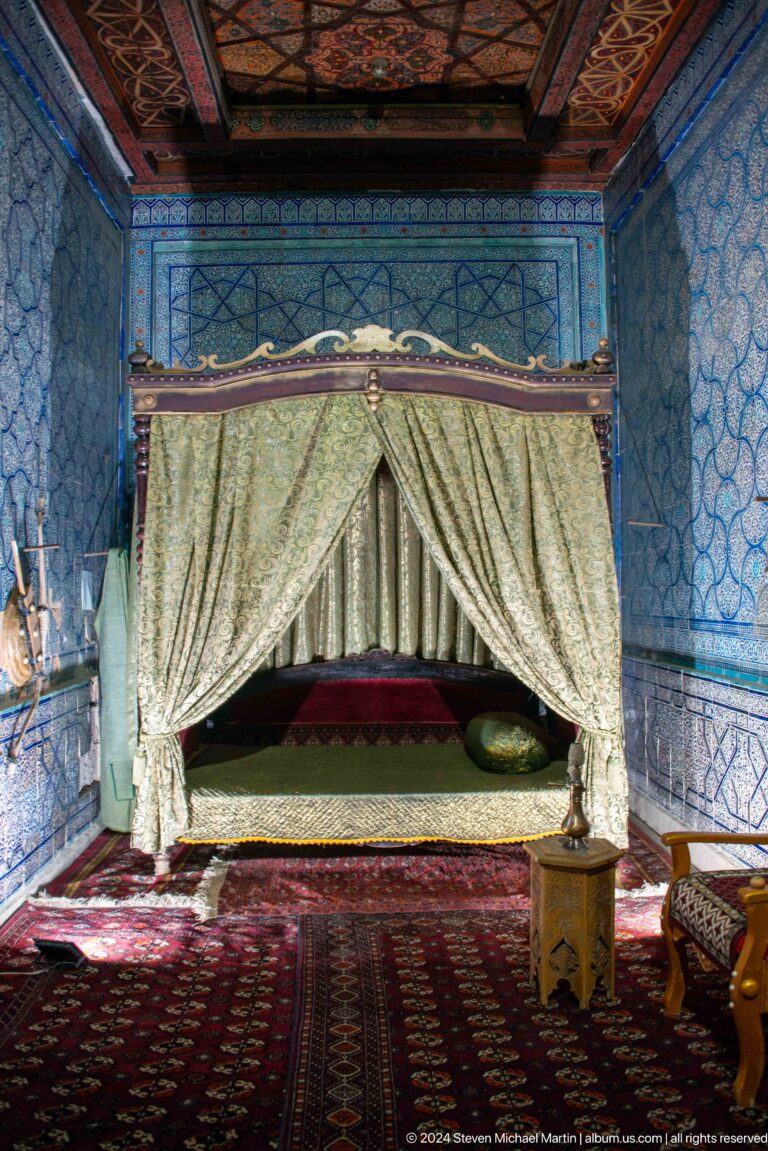 Closer view of canopied bed and textiles.