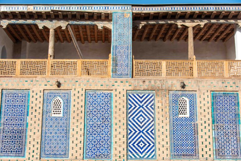 Blue-and-white facade with carved balcony screens.