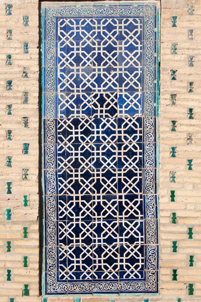 Dark blue star-and-cross tile panel.