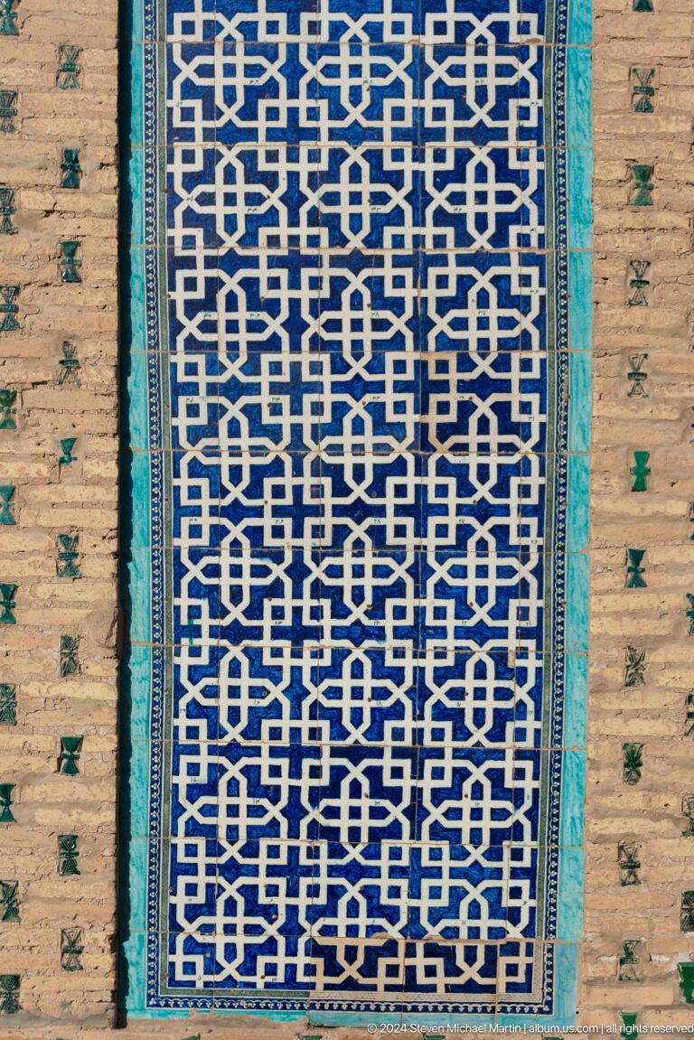 Interlaced blue lattice pattern in glazed tile.