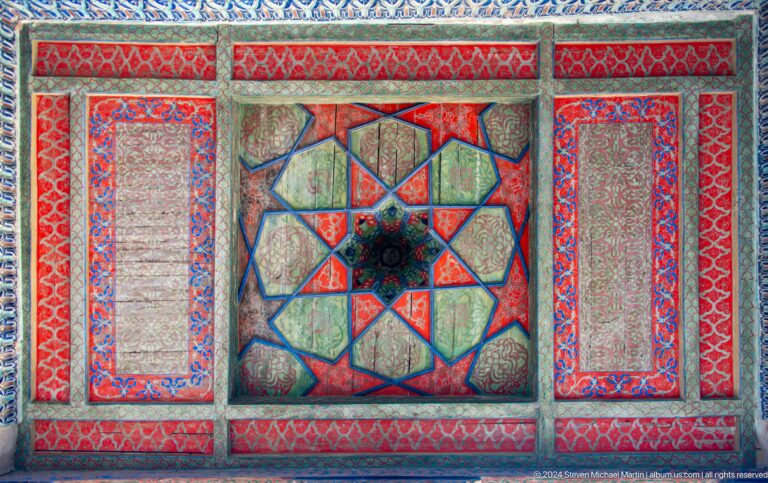 Red painted ceiling panel with multicolored star center.