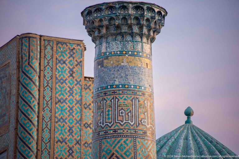 Close view of a tiled minaret beside the ribbed turquoise dome of Sher-Dor Madrasa.