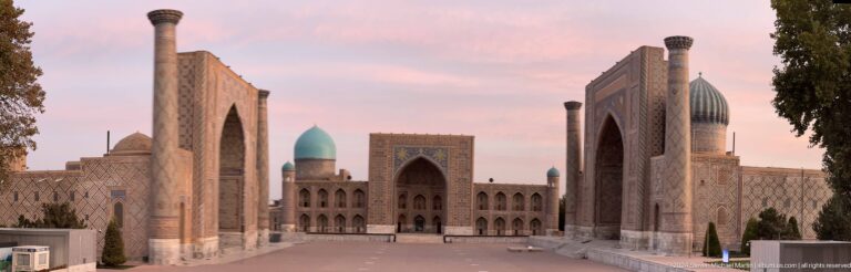 Centered view of Tilya-Kori Madrasa with its turquoise dome beyond the broad plaza.