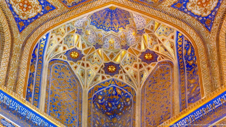 Blue-and-gold vaulted ceiling divided by pale ribs into star-shaped geometric compartments.