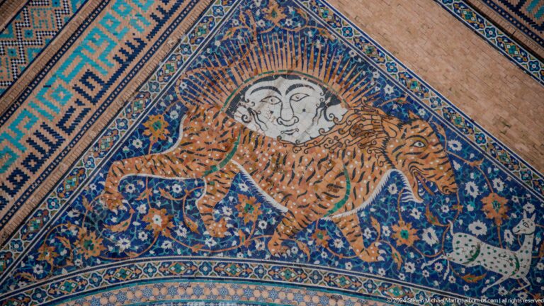 Figurative mosaic of a striped feline chasing a deer beneath a human-faced sun at Sher-Dor Madrasa.