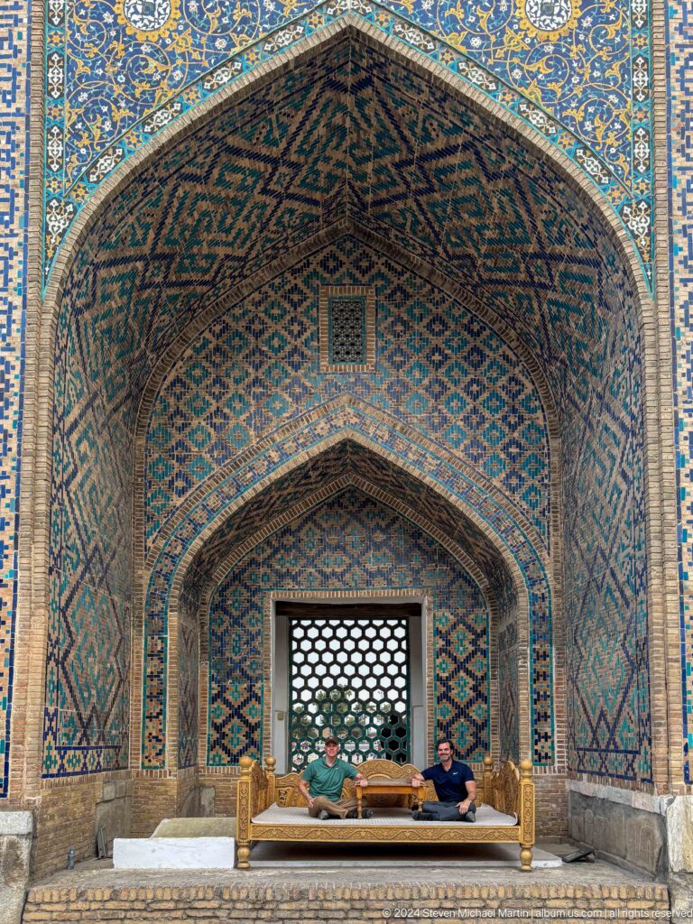 Pointed niche covered in blue and turquoise tilework above a honeycomb lattice opening.