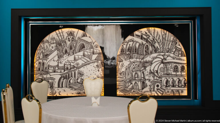 Two illuminated arched black-and-white murals showing domes, arcades, and historic architectural scenes.