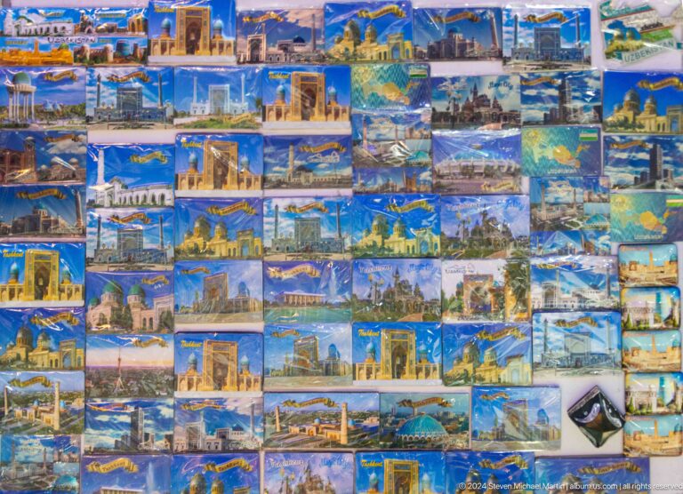 Wall covered with souvenir postcards and photographs of Tashkent.