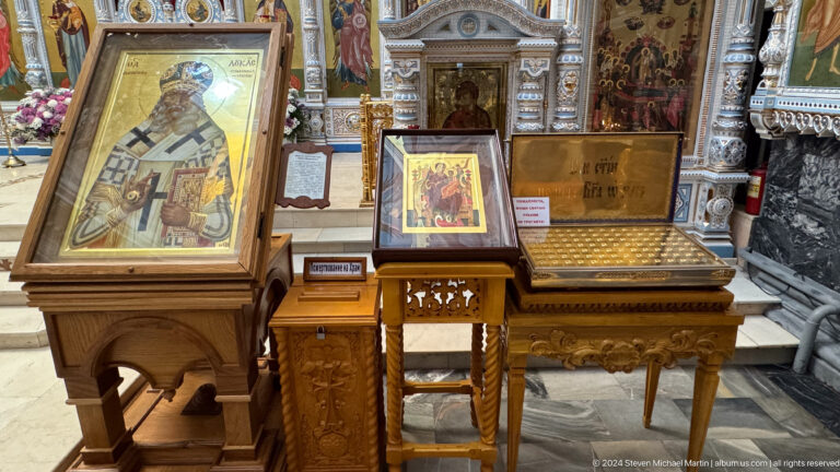 Several wooden stands displaying icons and liturgical books inside the cathedral.
