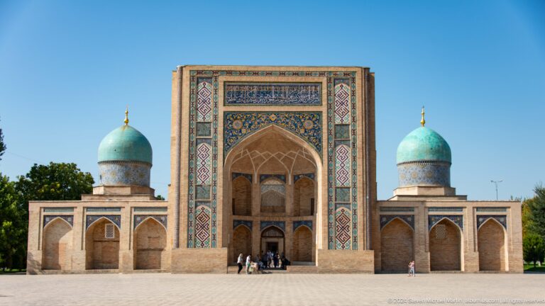 Tall tiled pishtaq centered between two turquoise domed corner towers at the Khast Imom complex in Tashkent.