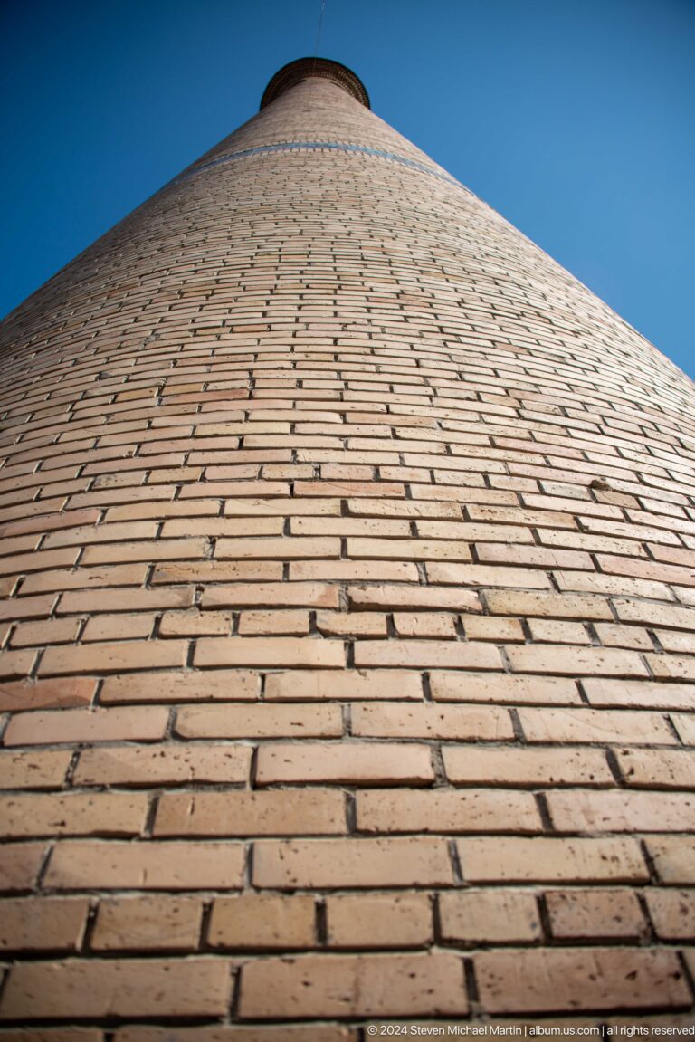Curving field of tightly laid tan bricks seen at close range at the Khast Imom complex in Tashkent.