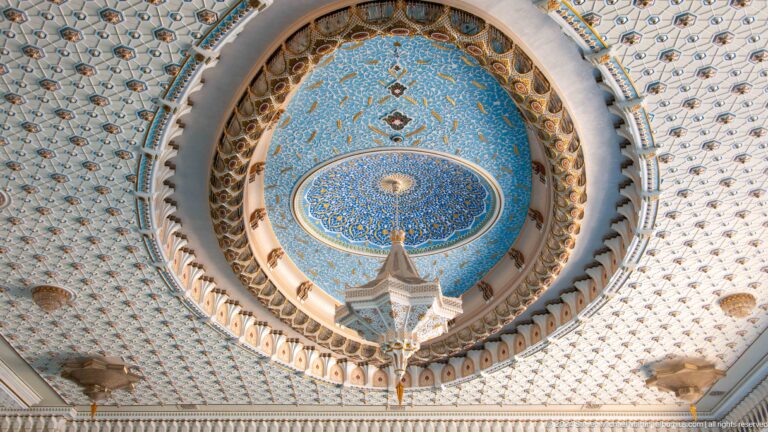 Circular blue-and-gold ceiling medallion above a faceted hanging chandelier at the Khast Imom complex in Tashkent.