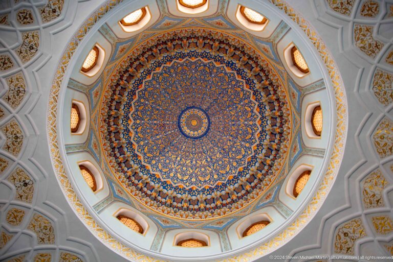 Concentric blue, gold, and red ornament filling a circular ceiling recess at the Khast Imom complex in Tashkent.