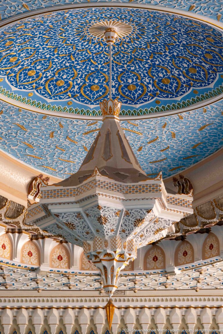 Faceted pendant suspended below a turquoise painted dome and carved cornice at the Khast Imom complex in Tashkent.