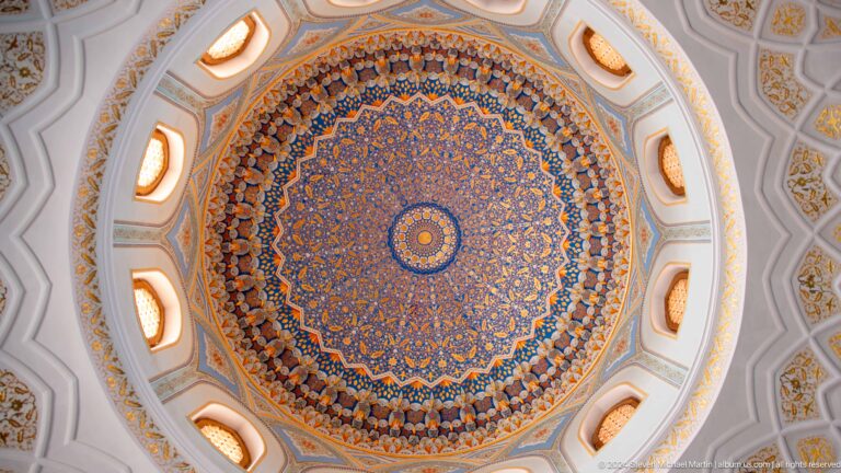 Symmetrical blue, gold, and red medallion framed by white oval openings at the Khast Imom complex in Tashkent.