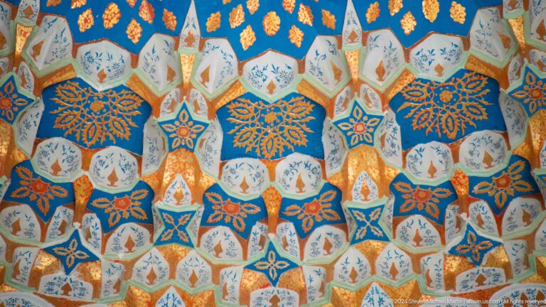 Repeating turquoise, blue, gold, and white blossoms in a tessellated ceiling pattern at the Khast Imom complex in Tashkent.