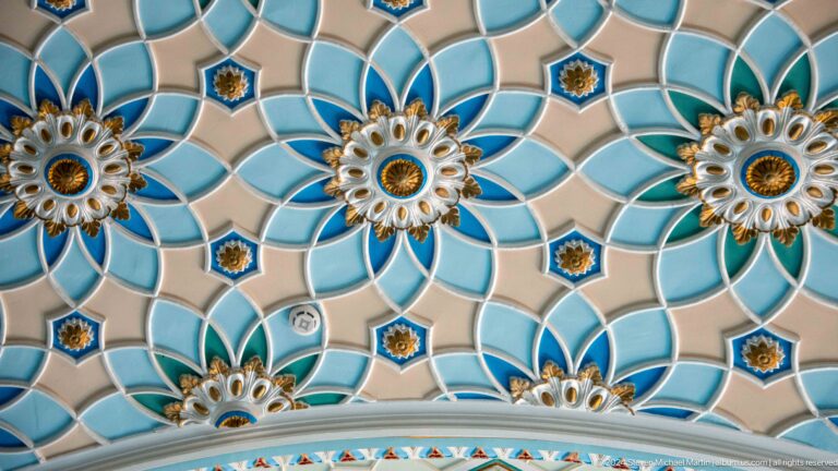 Large turquoise-and-white petal forms with small dark-blue star centers at the Khast Imom complex in Tashkent.