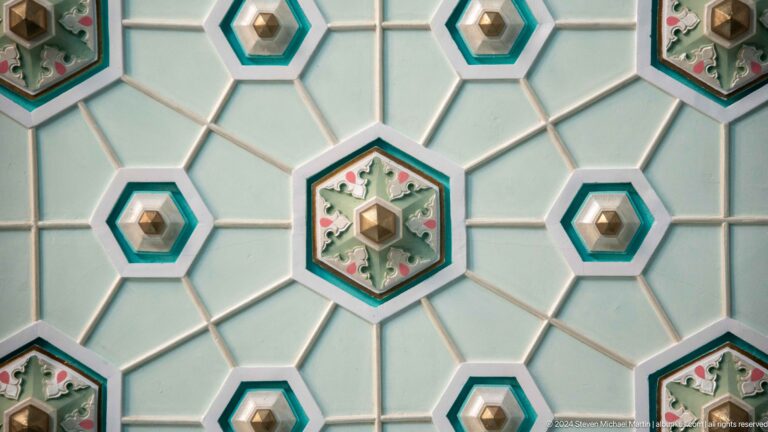 White polygonal grid with turquoise outlines and small floral medallions at the Khast Imom complex in Tashkent.