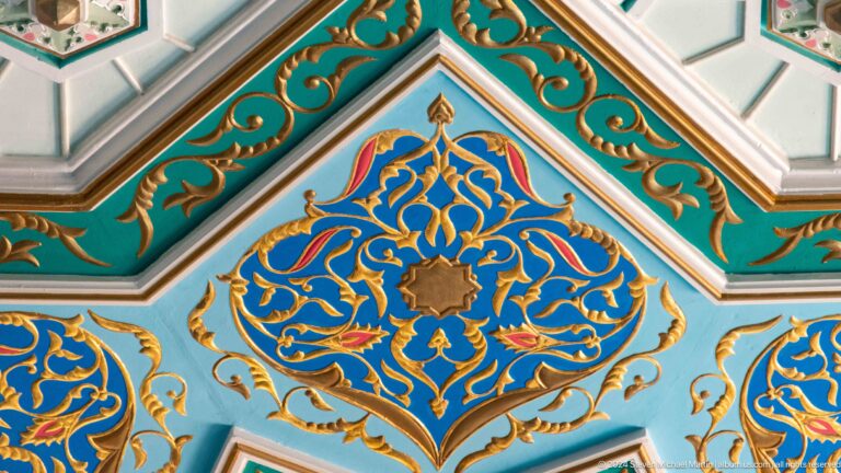 Central gold flower enclosed by symmetrical dark-blue arabesques on turquoise ground at the Khast Imom complex in Tashkent.