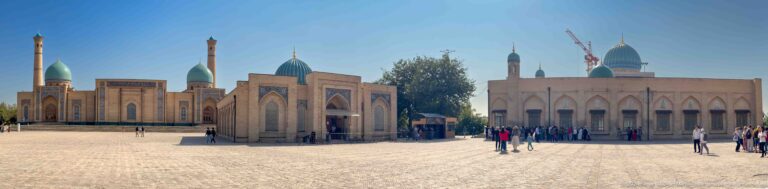Low brick facade with turquoise dome and shaded entrance across wide square at the Khast Imom complex in Tashkent.