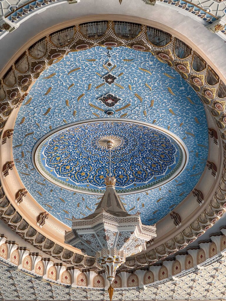 Large blue floral dome with ring of windows and hanging faceted chandelier at the Khast Imom complex in Tashkent.