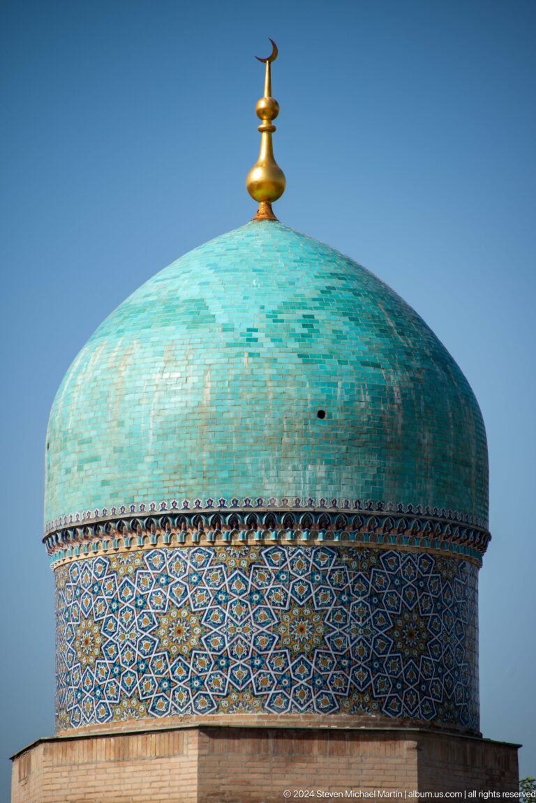 Rounded turquoise dome with weathered tile surface and patterned drum at the Khast Imom complex in Tashkent.