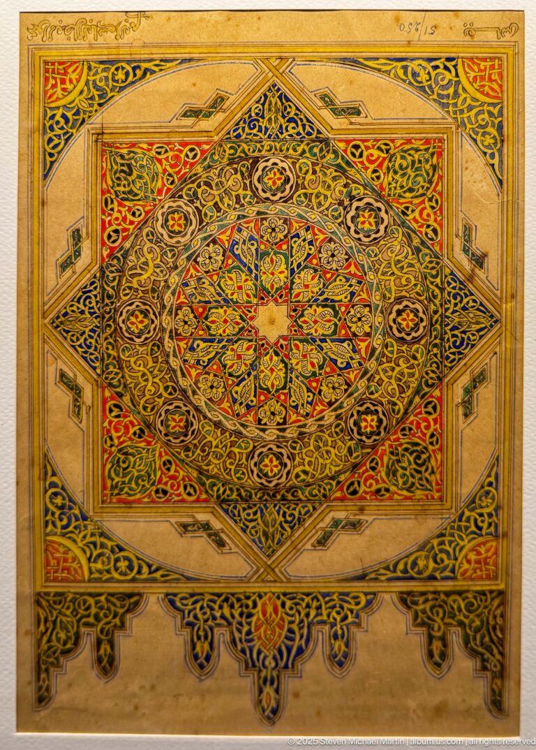 Polychrome rectangular panel with a central radiating star medallion, interlaced ornament, smaller rosettes, and geometric borders.