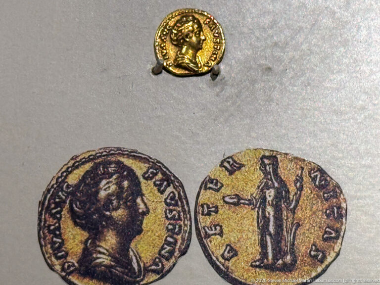 Small gold coin mounted above enlarged obverse and reverse images with portrait, standing figure, and surrounding inscriptions.
