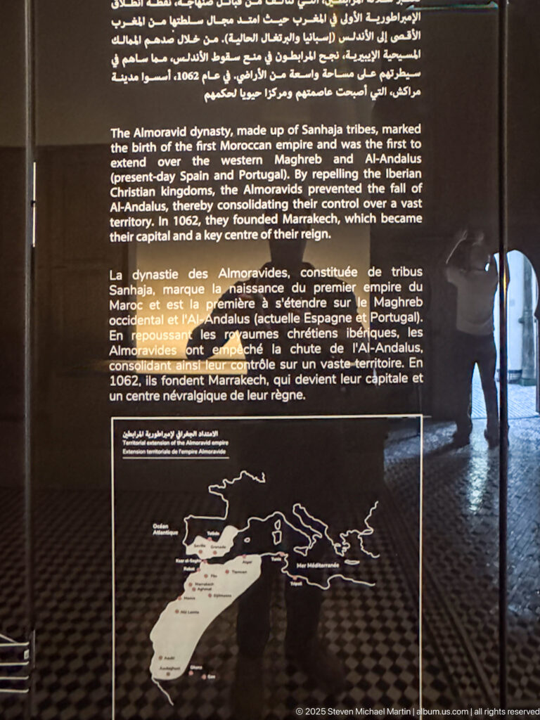Dark bilingual panel about the Almoravid dynasty with historical text and a map of Morocco and surrounding western Mediterranean lands.