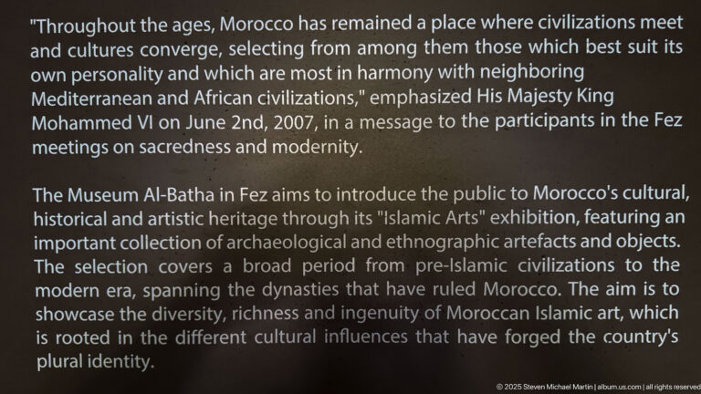 Dark museum wall panel with English text introducing Al-Batha, Moroccan cultural heritage, and the Islamic Arts exhibition.