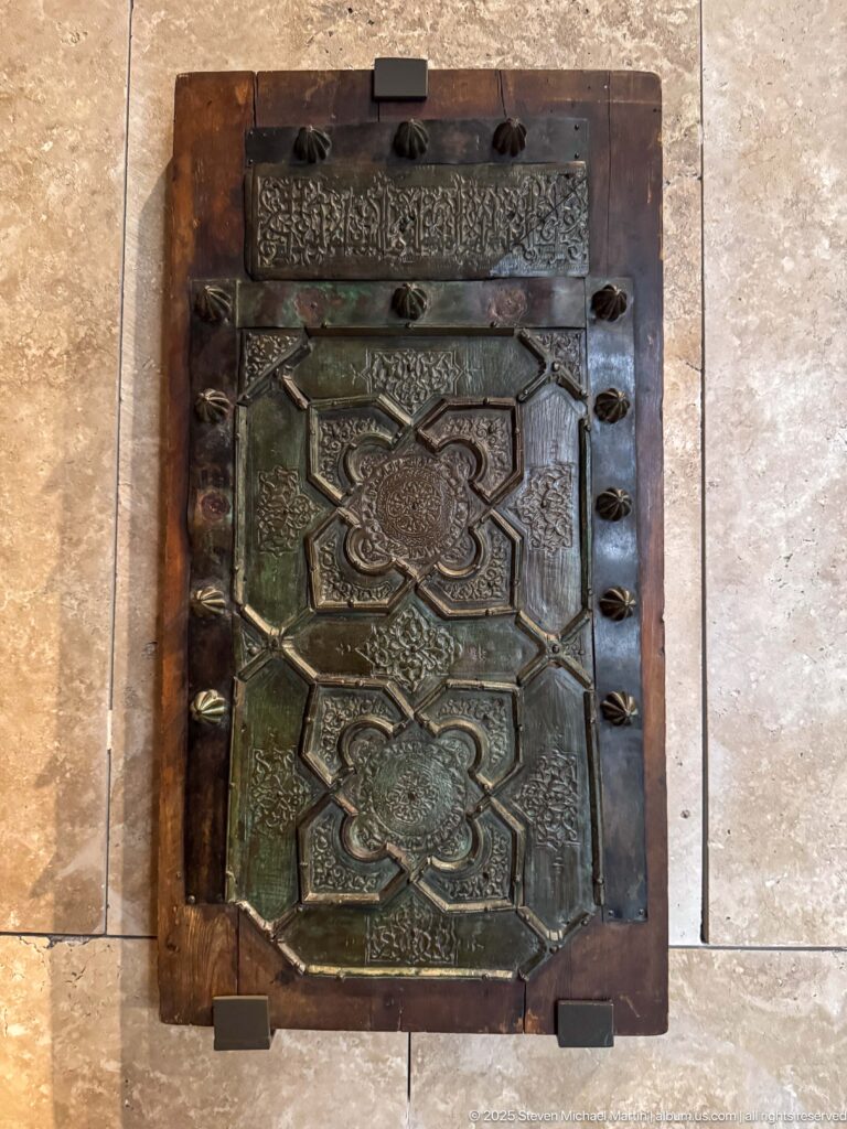 Almoravid bronze door-facing fragments from the Qarawiyyin Mosque, dated 1136, with geometric panels, Arabic inscriptions, and projecting studs.