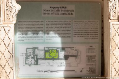 Room of Lalla Massouda interpretation panel with multilingual text and a highlighted floor plan of the tomb complex.