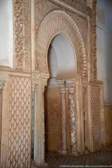 Horseshoe-arched niche with marble colonnettes, carved stucco, and lattice panels.