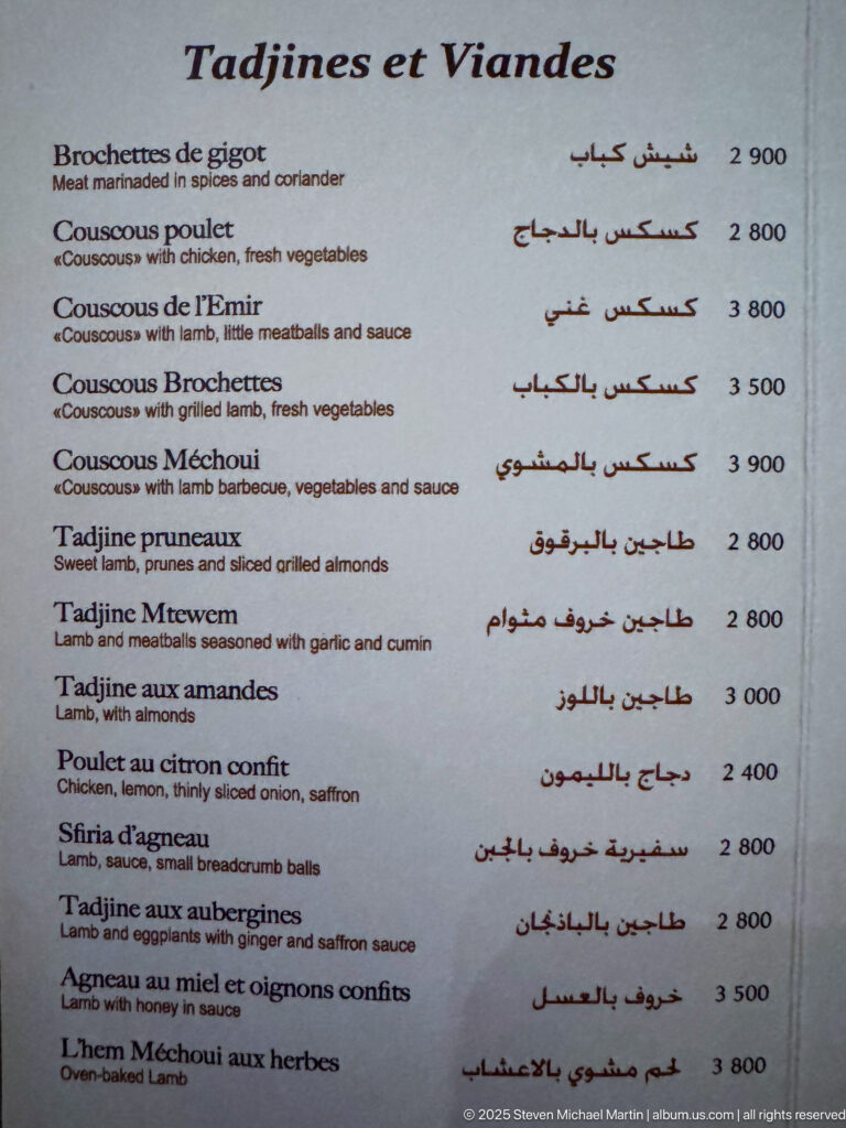 French-and-Arabic restaurant menu titled “Tajines et Viandes” listing couscous, tajines, meats, and prices.