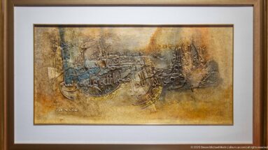 Framed Arabic calligraphic artwork with layered dark script across a textured gold-brown background.